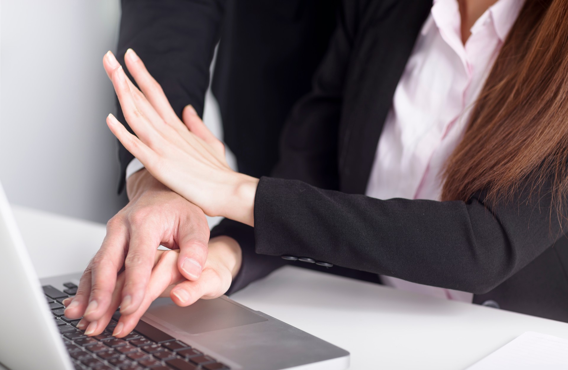 Business man touching woman hand feeling disgusted and uncomfortable. Sexual harassment inappropriate at office